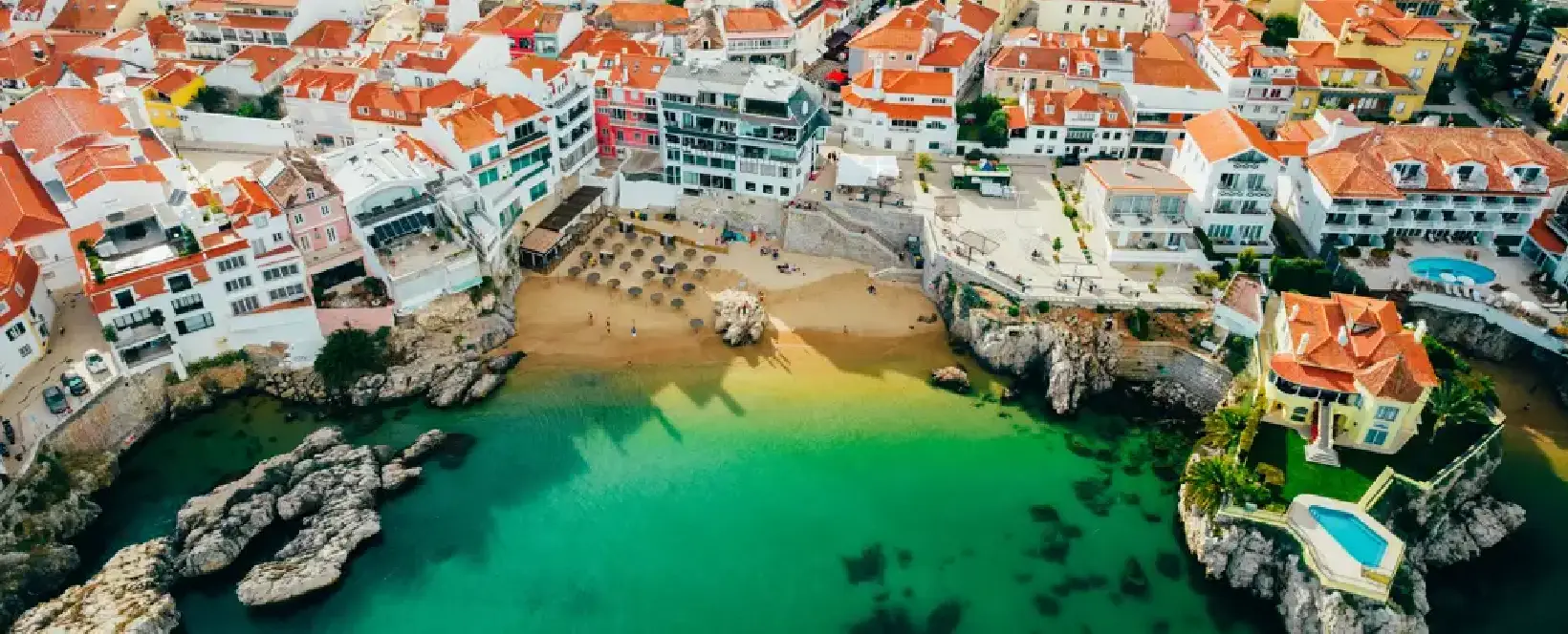 Luxury real estate on the Portugal coast featuring modern villas and the Cascais marina skyline.