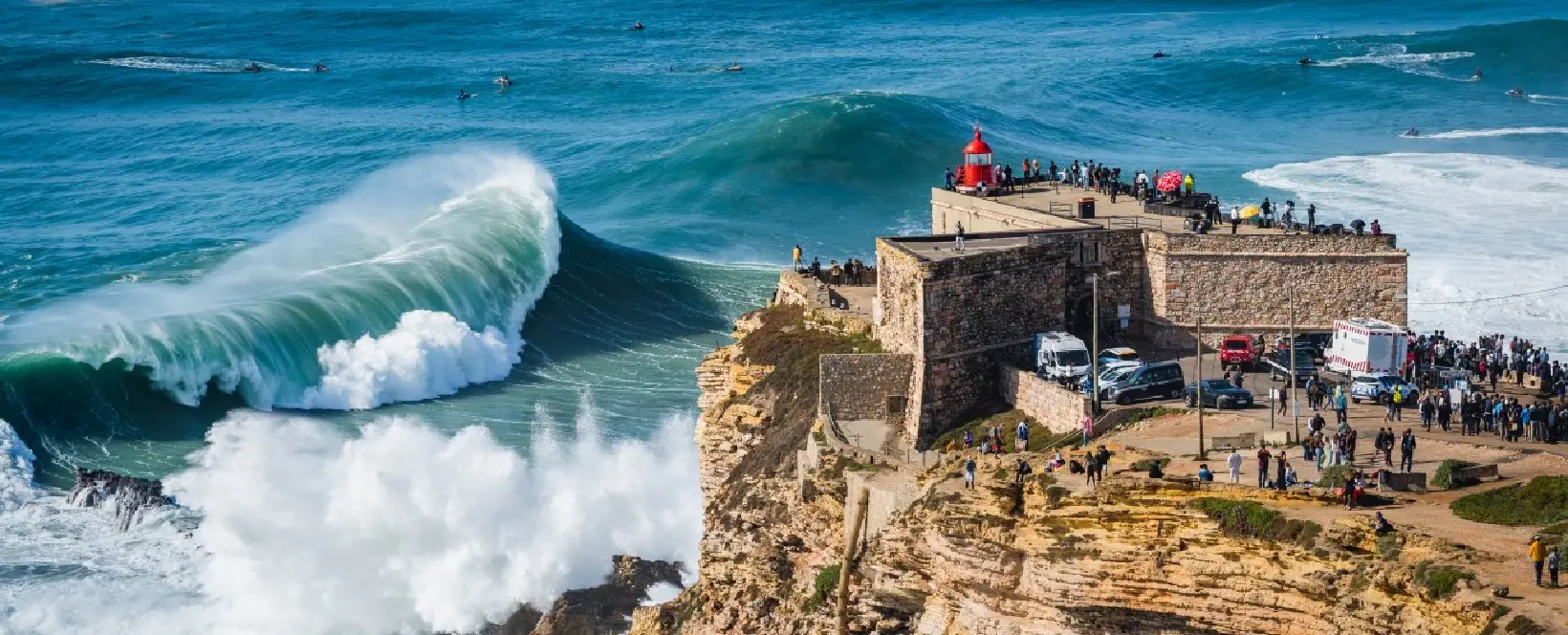 Nazaré shoreline showcasing the natural beauty and giant waves that drive the real estate market on the Portugal coast.