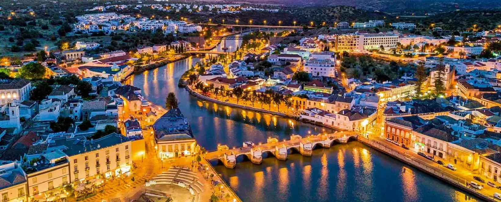 The Roman Bridge and historic riverside architecture of Tavira, an unspoiled gem for real estate on the Portugal coast.
